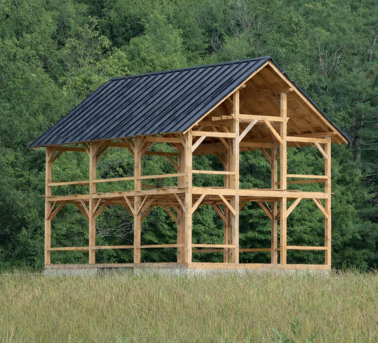 large custom timber frame post and beam barn and ADU in vermont using local wood