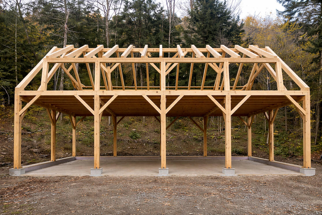 Custom timber frame post and beam barn garage workshop and ADU in vermont using locally harvested trees